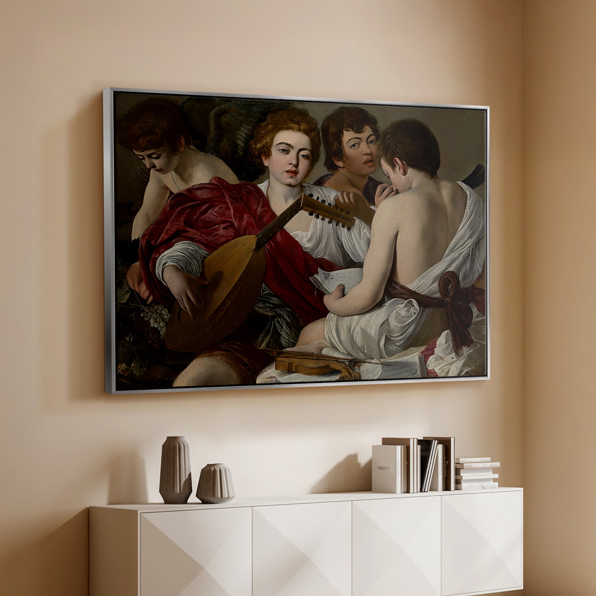 Silver floater framed canvas of The Musicians, c. 1595 by Caravaggio, featuring an ensemble of musicians holding lute and singing in close arrangement above a console cabinet in a minimalist entryway.