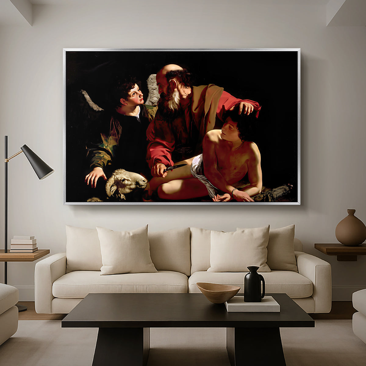 The Sacrifice of Isaac (Uffizi Version), c. 1603 by Caravaggio as a silver floater framed canvas featuring Abraham holding Isaac while angel intervenes to stop the sacrifice, displayed above a sofa in a modern living room.