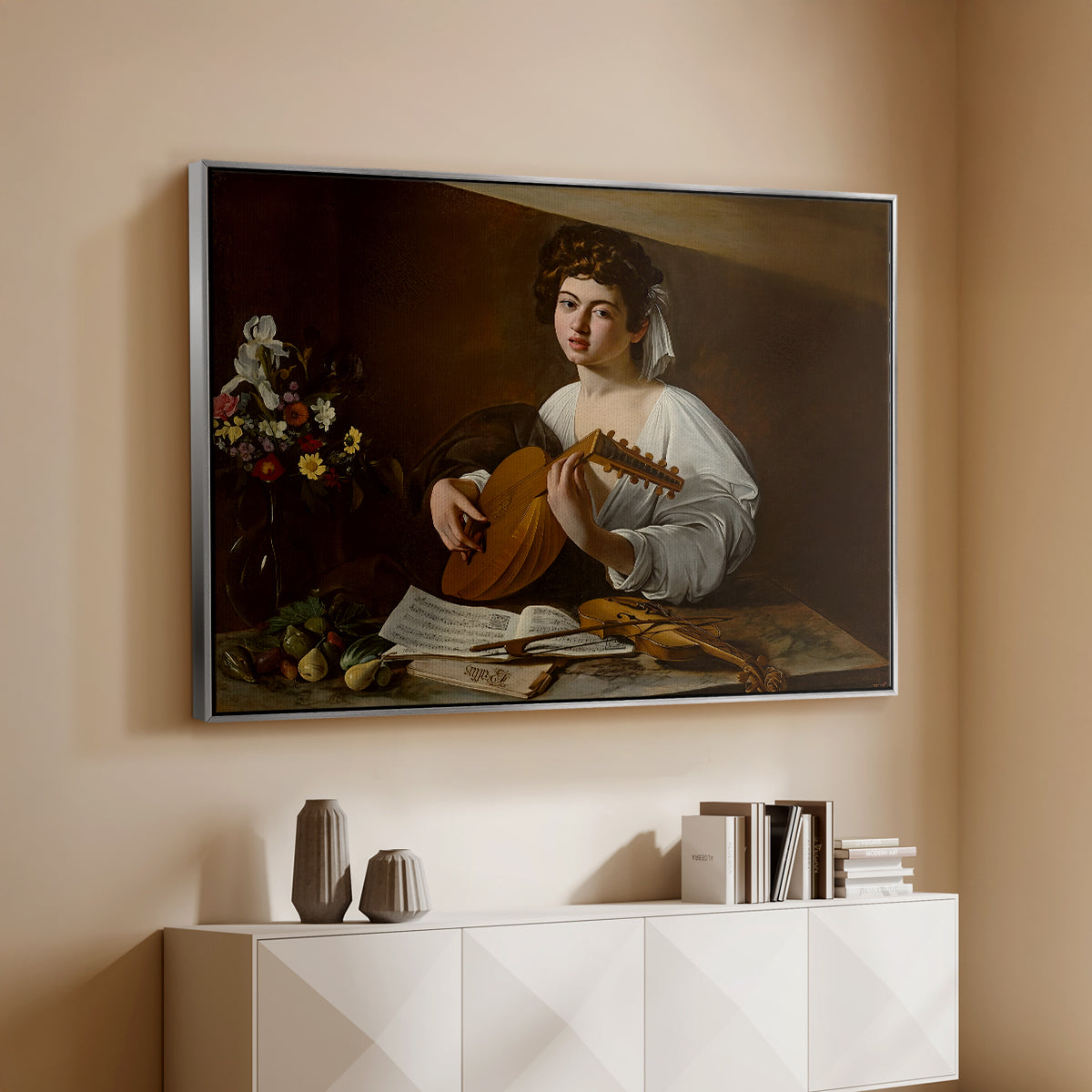 Silver floater framed canvas of The Lute Player (Hermitage Version), c. 1596 by Caravaggio, featuring a portrait of lute player surrounded by still life arrangement above a console cabinet in a minimalist entryway.