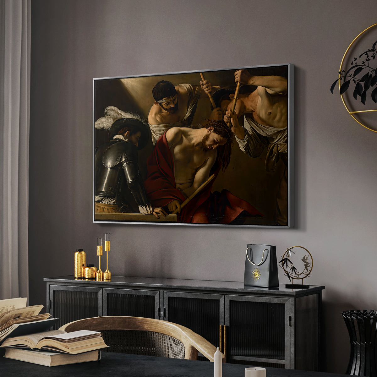 The Crowning with Thorns (Vienna Version), c. 1602-1604 by Caravaggio in a silver floater framed canvas featuring a dramatic depiction of figures forcing thorn crown onto Christ, displayed above a desk in a dark home office interior.