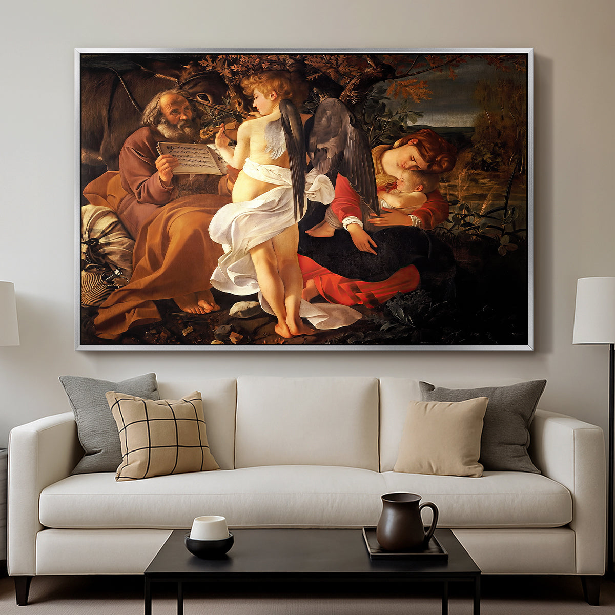 Rest on the Flight into Egypt, c. 1597 by Caravaggio displayed in a silver floater framed canvas above a sofa in a clean living room.