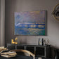 Charing Cross Bridge, 1903 by Claude Monet in a silver floater framed canvas featuring an atmospheric depiction of London bridge with reflections in water, displayed above a desk in a dark home office interior.