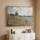 Silver floater framed canvas of The Poppy Field near Argenteuil, 1873 by Claude Monet, featuring an impressionist countryside scene with flowers and strolling figures above a console cabinet in a minimalist entryway.