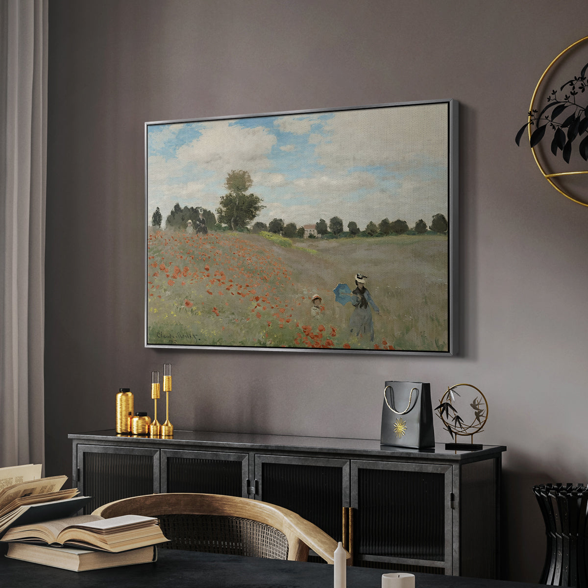 The Poppy Field near Argenteuil, 1873 by Claude Monet in a silver floater framed canvas featuring a bright meadow filled with poppies under open sky, displayed above a desk in a dark home office interior.