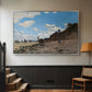 Silver floater framed canvas featuring a coastal landscape with boats and people along shore, displayed in a hallway near a staircase.