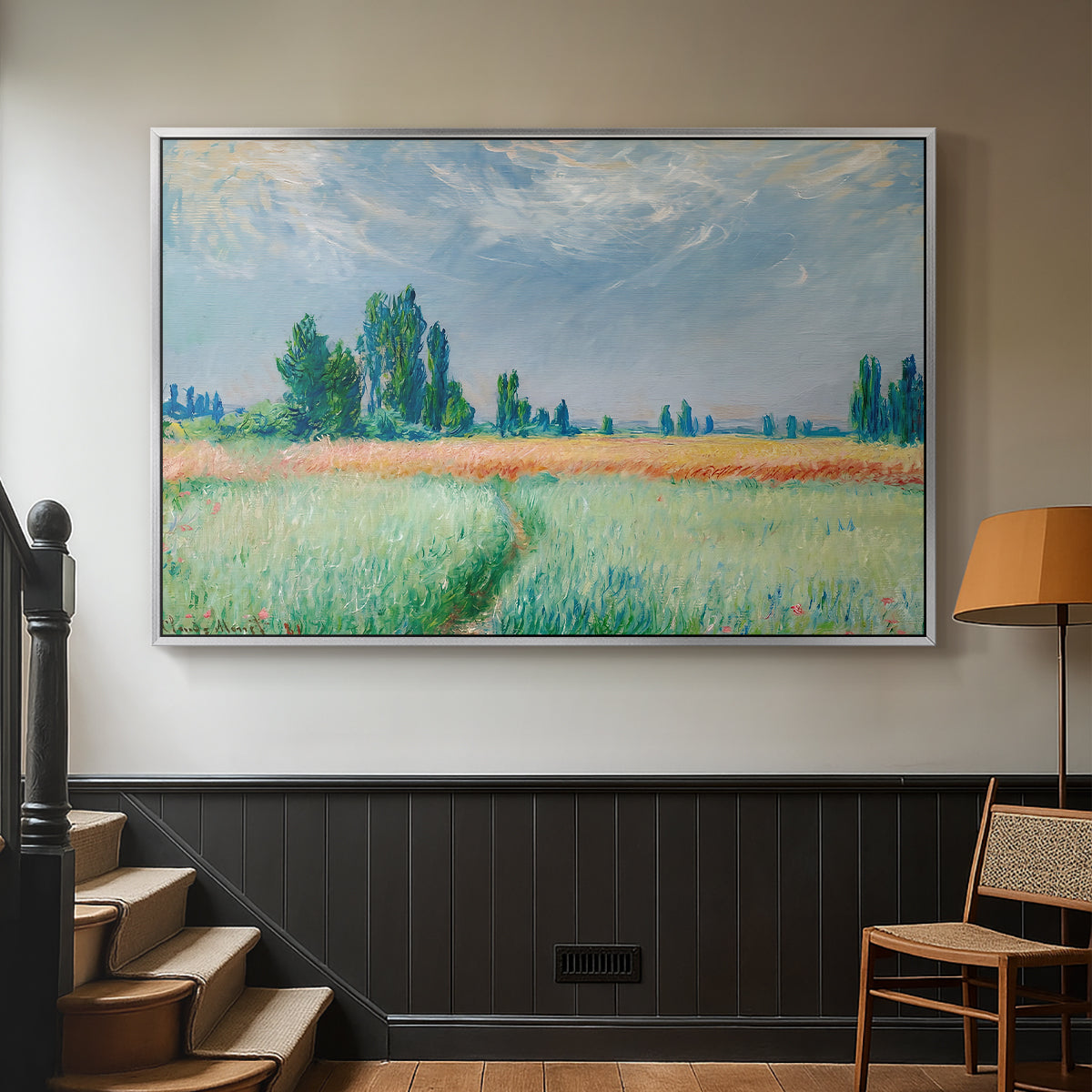 Silver floater framed canvas featuring a serene rural scene with textured wheat under natural light, displayed in a hallway near a staircase.