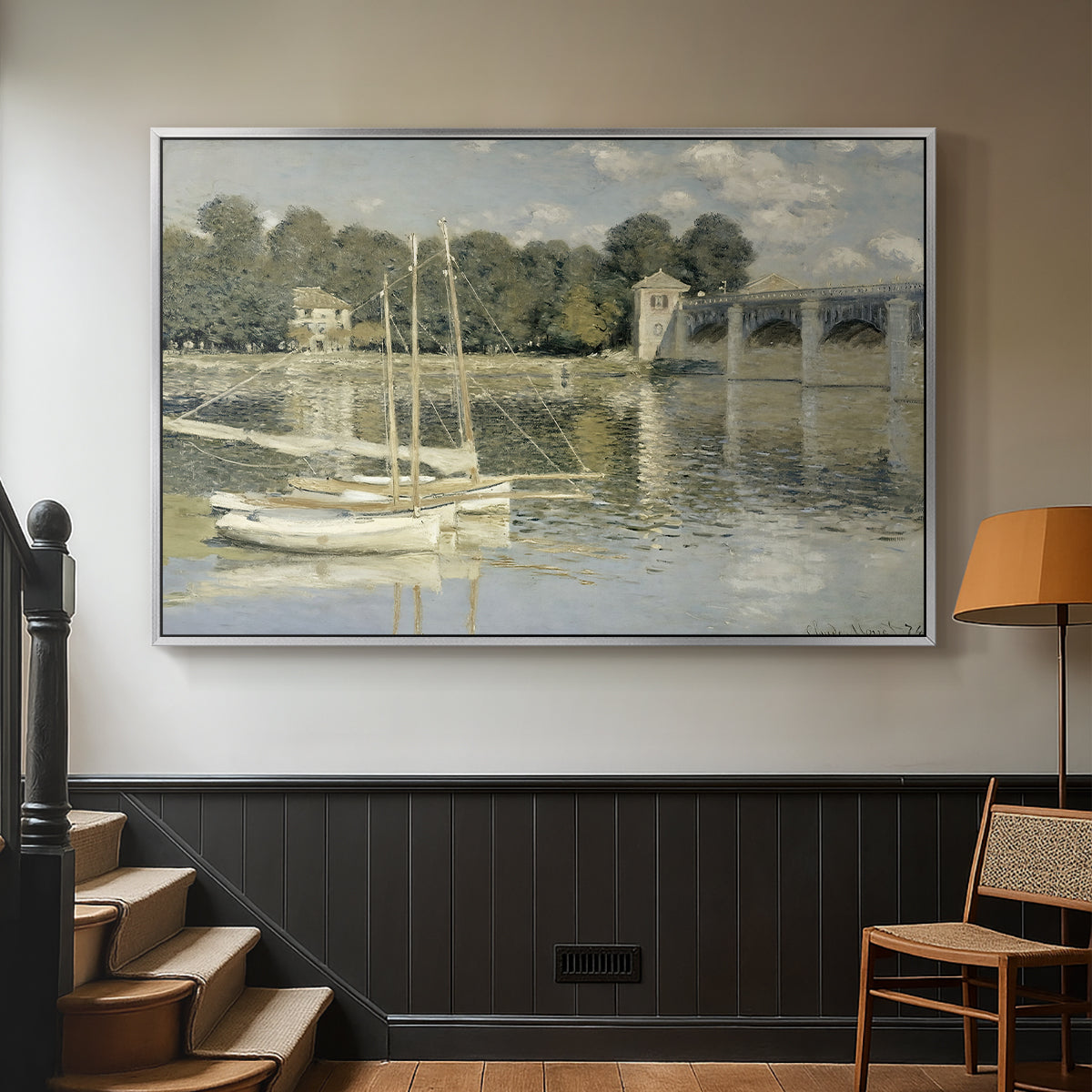 Silver floater framed canvas featuring a riverside view with architecture and nautical activity, displayed in a hallway near a staircase.