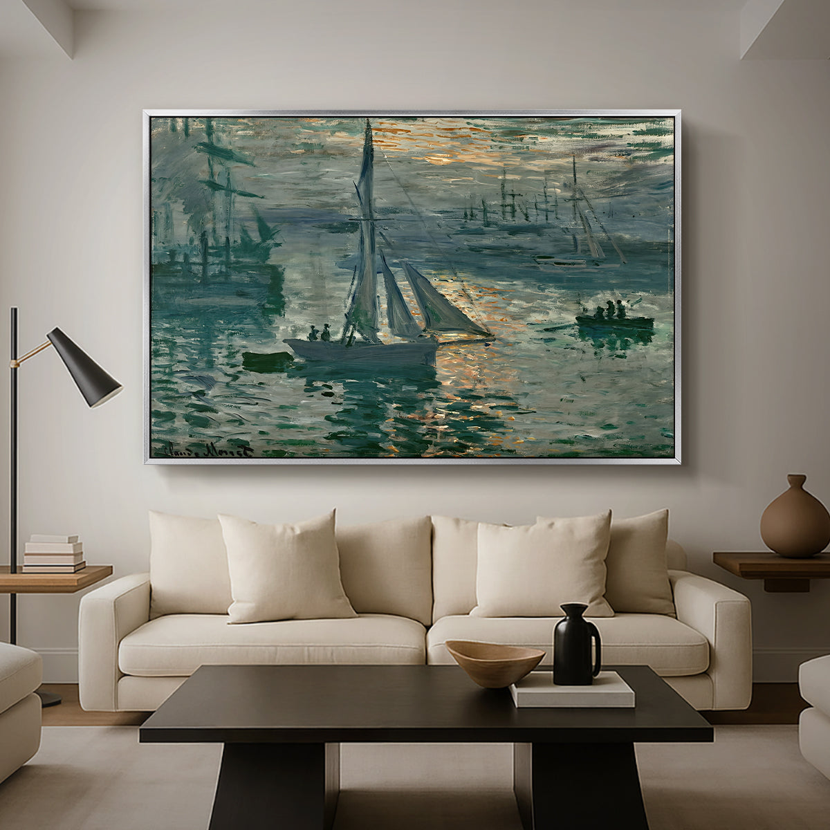 Sunrise (Marine), 1873 by Claude Monet as a silver floater framed canvas featuring a hazy sunrise over harbor with boats silhouetted in soft morning light, displayed above a sofa in a modern living room.