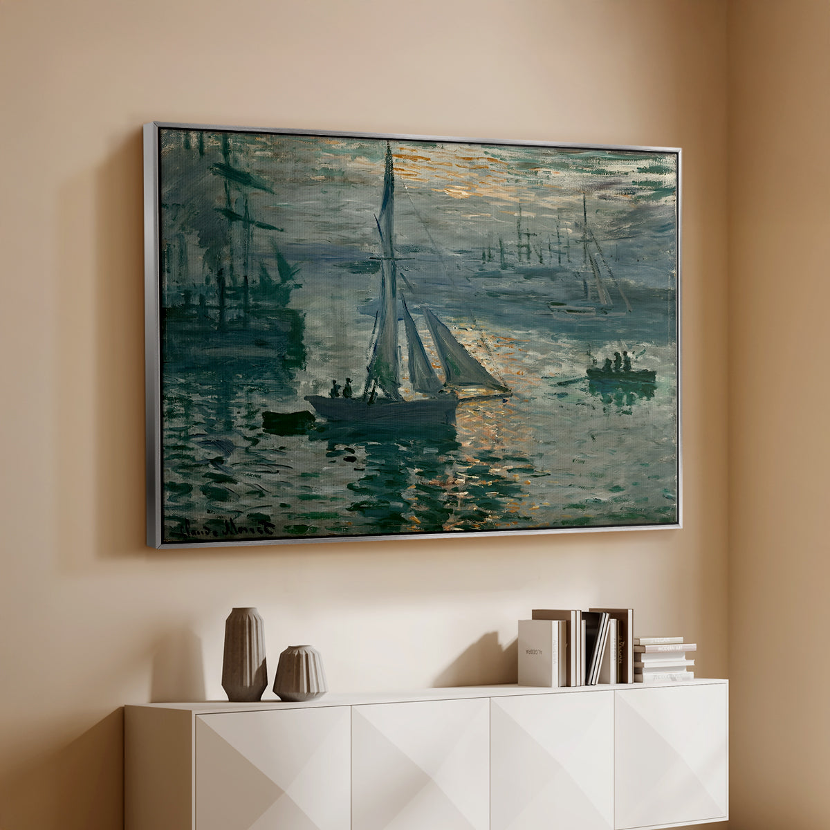 Silver floater framed canvas of Sunrise (Marine), 1873 by Claude Monet, featuring an impressionist seascape with glowing sun and misty water above a console cabinet in a minimalist entryway.