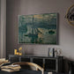 Sunrise (Marine), 1873 by Claude Monet in a silver floater framed canvas featuring an early morning harbor scene with boats and diffused light, displayed above a desk in a dark home office interior.