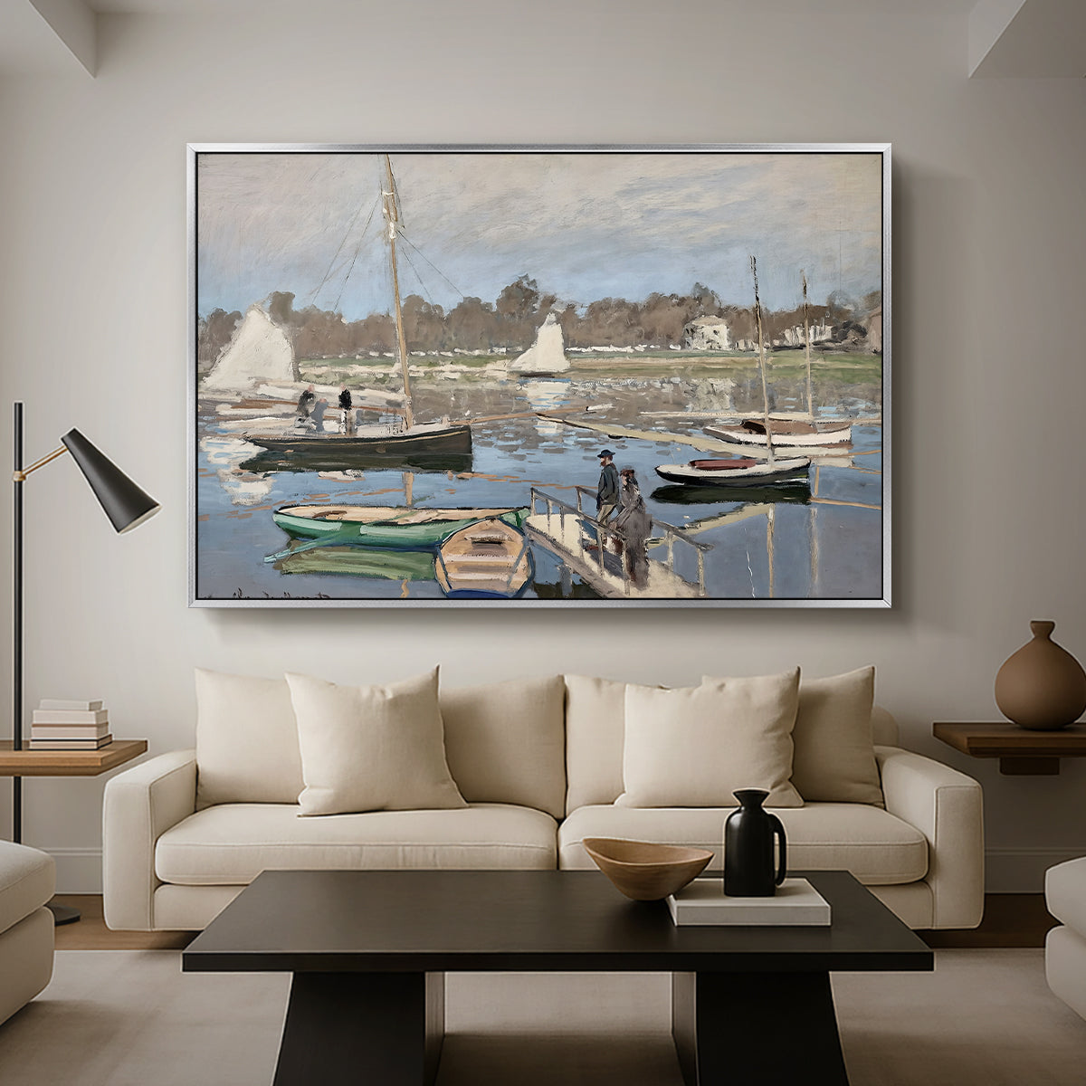 The Basin at Argenteuil, 1874 by Claude Monet as a silver floater framed canvas featuring sailboats gathered in calm basin with reflections on water, displayed above a sofa in a modern living room.