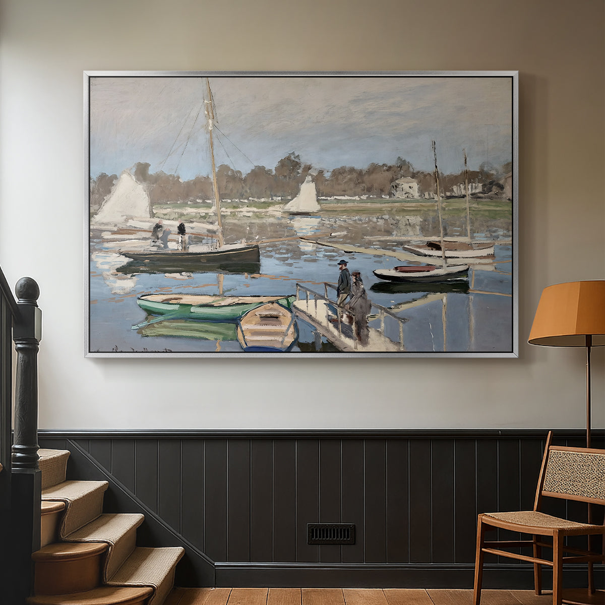 Silver floater framed canvas featuring a tranquil river setting with sailboats and shoreline, displayed in a hallway near a staircase.
