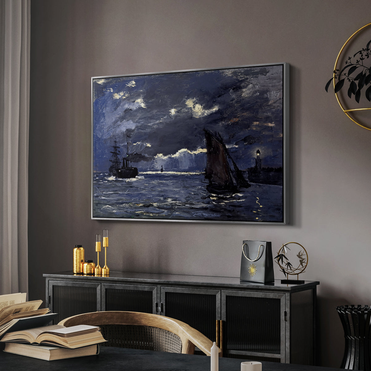 A Seascape, Shipping by Moonlight, 1864 by Claude Monet in a silver floater framed canvas featuring a dramatic ocean scene with light reflecting across water at night, displayed above a desk in a dark home office interior.