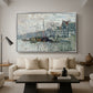 View of the Prins Hendrikkade and Kromme Waal in Amsterdam, 1874 by Claude Monet as a silver floater framed canvas featuring a canal scene with boats and buildings lining waterfront in Amsterdam, displayed above a sofa in a modern living room.