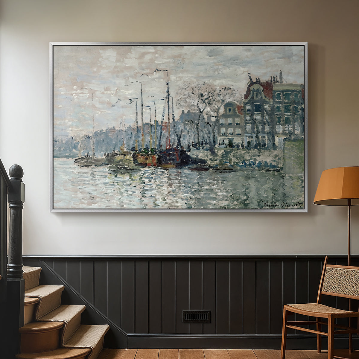Silver floater framed canvas featuring a harbor view with masts, houses, and reflections in water, displayed in a hallway near a staircase.