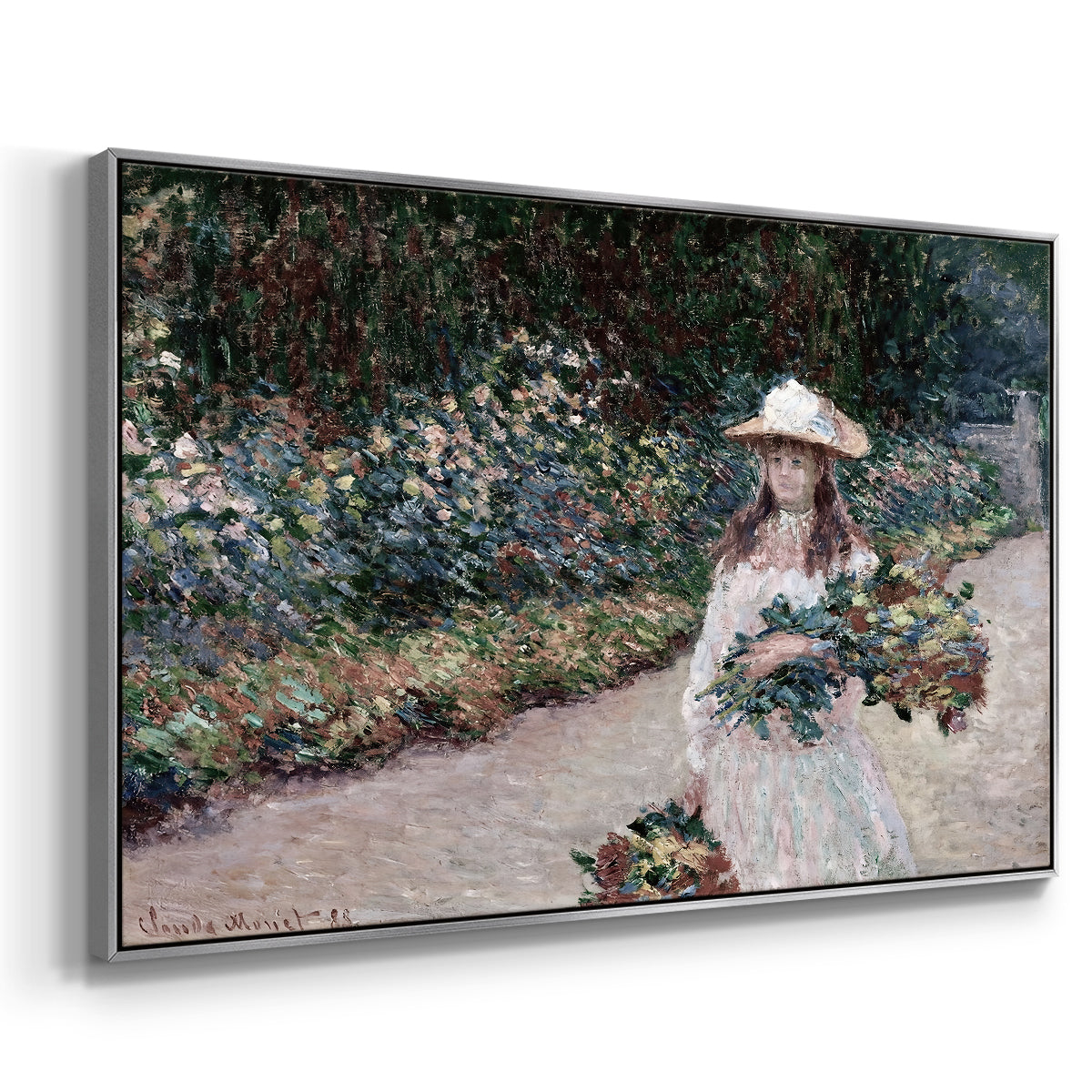Angled view of Young Girl in the Garden at Giverny, 1888 by Claude Monet in a silver floater framed canvas.