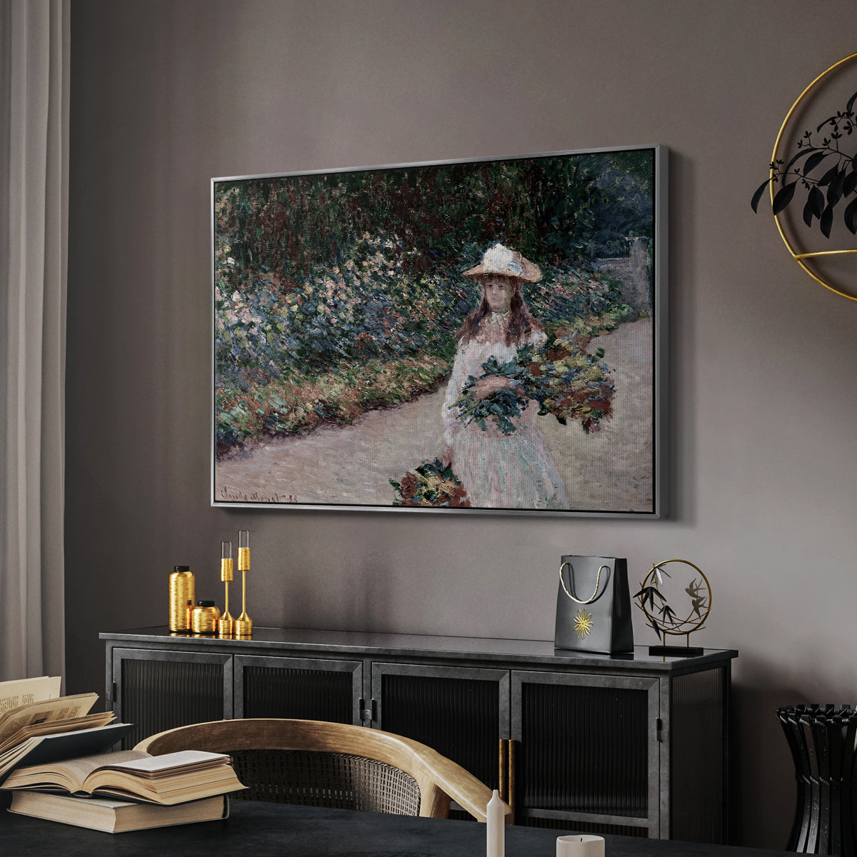 Young Girl in the Garden at Giverny, 1888 by Claude Monet in a silver floater framed canvas featuring a figure resting in colorful garden under soft light, displayed above a desk in a dark home office interior.