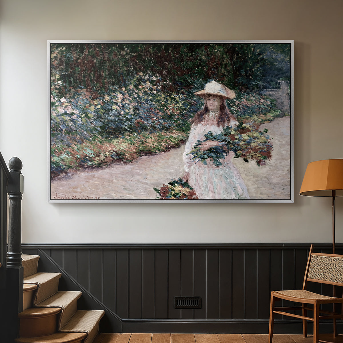 Silver floater framed canvas featuring a tranquil outdoor portrait of girl in floral setting, displayed in a hallway near a staircase.