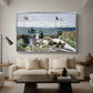 Garden at Sainte-Adresse, 1867 by Claude Monet as a silver floater framed canvas featuring a seaside garden with flowers, flags, and figures overlooking the water, displayed above a sofa in a modern living room.