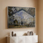 Silver floater framed canvas of The Gare Saint-Lazare, 1877 by Claude Monet, featuring an impressionist scene of trains and smoke inside busy railway station above a console cabinet in a minimalist entryway.