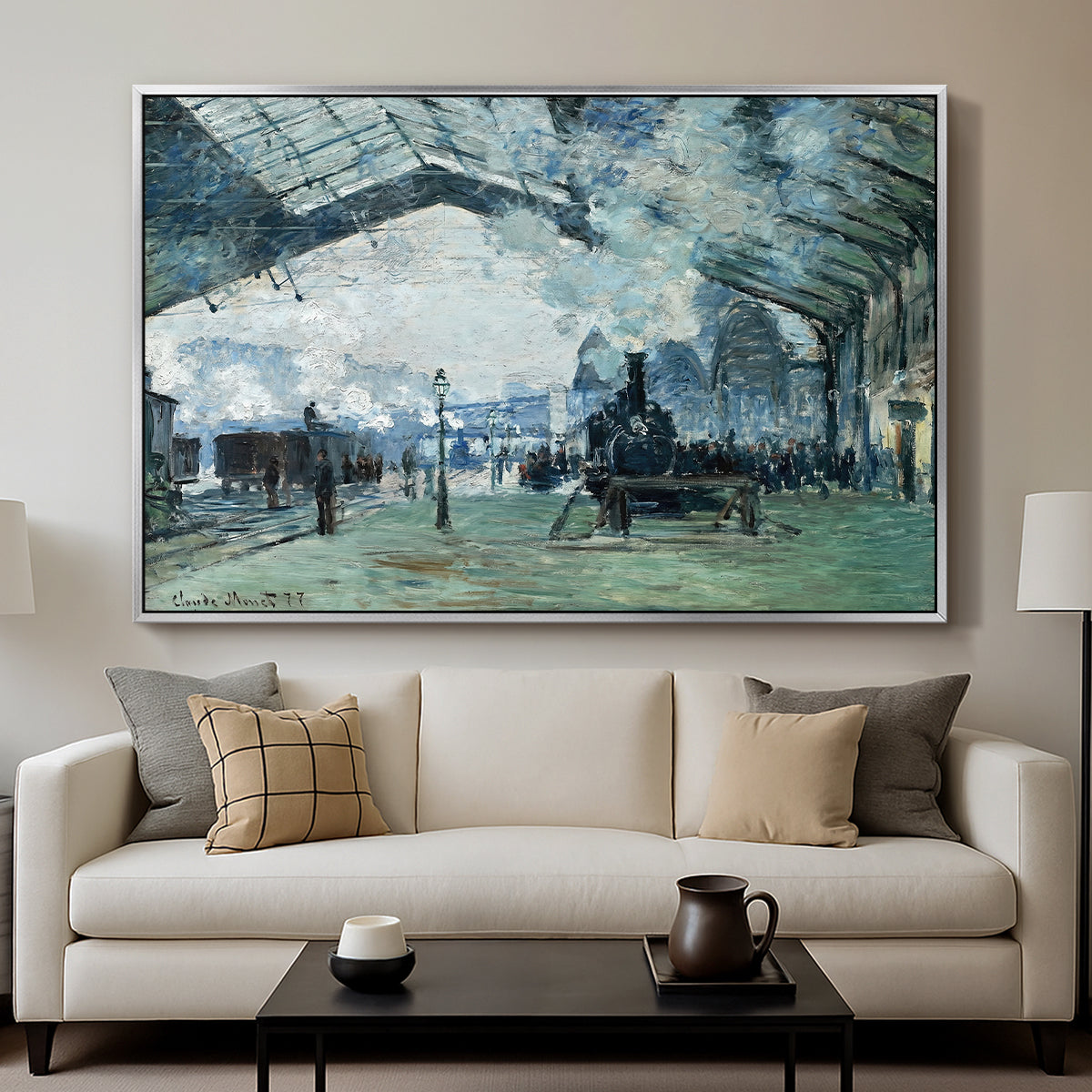 The Saint-Lazare Station, 1877 by Claude Monet displayed in a silver floater framed canvas above a sofa in a clean living room.