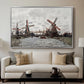 Windmills near Zaandam, 1871 by Claude Monet displayed in a silver floater framed canvas above a sofa in a clean living room.