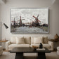 Windmills near Zaandam, 1871 by Claude Monet as a silver floater framed canvas featuring windmills standing beside water under open sky in rural landscape, displayed above a sofa in a modern living room.