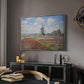 Tulip Fields with the Rijnsburg Windmill, 1886 by Claude Monet in a silver floater framed canvas featuring an impressionist field of blooming tulips under bright sky, displayed above a desk in a dark home office interior.