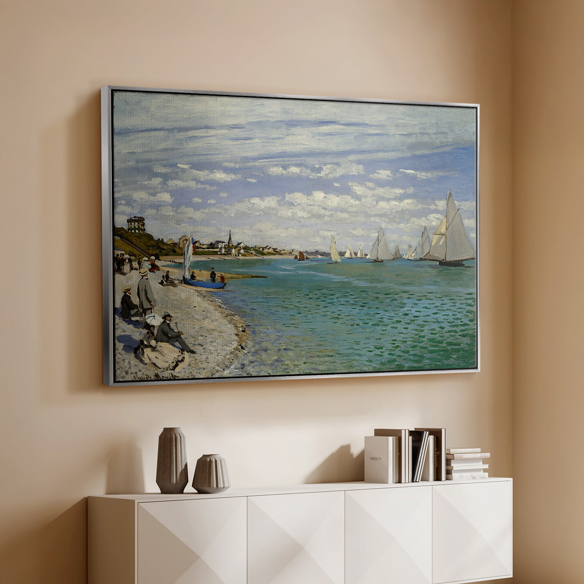 Silver floater framed canvas of Regatta at Sainte-Adresse, 1867 by Claude Monet, featuring a lively regatta scene with boats and people on beach above a console cabinet in a minimalist entryway.
