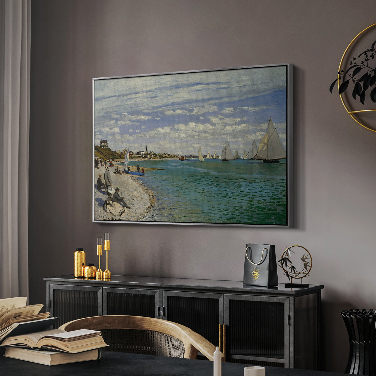 Regatta at Sainte-Adresse, 1867 by Claude Monet in a silver floater framed canvas featuring an impressionist coastal view with colorful sails and shoreline activity, displayed above a desk in a dark home office interior.