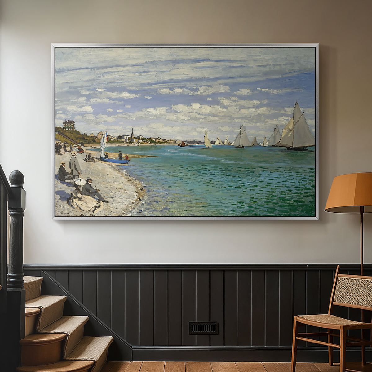 Silver floater framed canvas featuring a nautical scene with boats racing near seaside town, displayed in a hallway near a staircase.