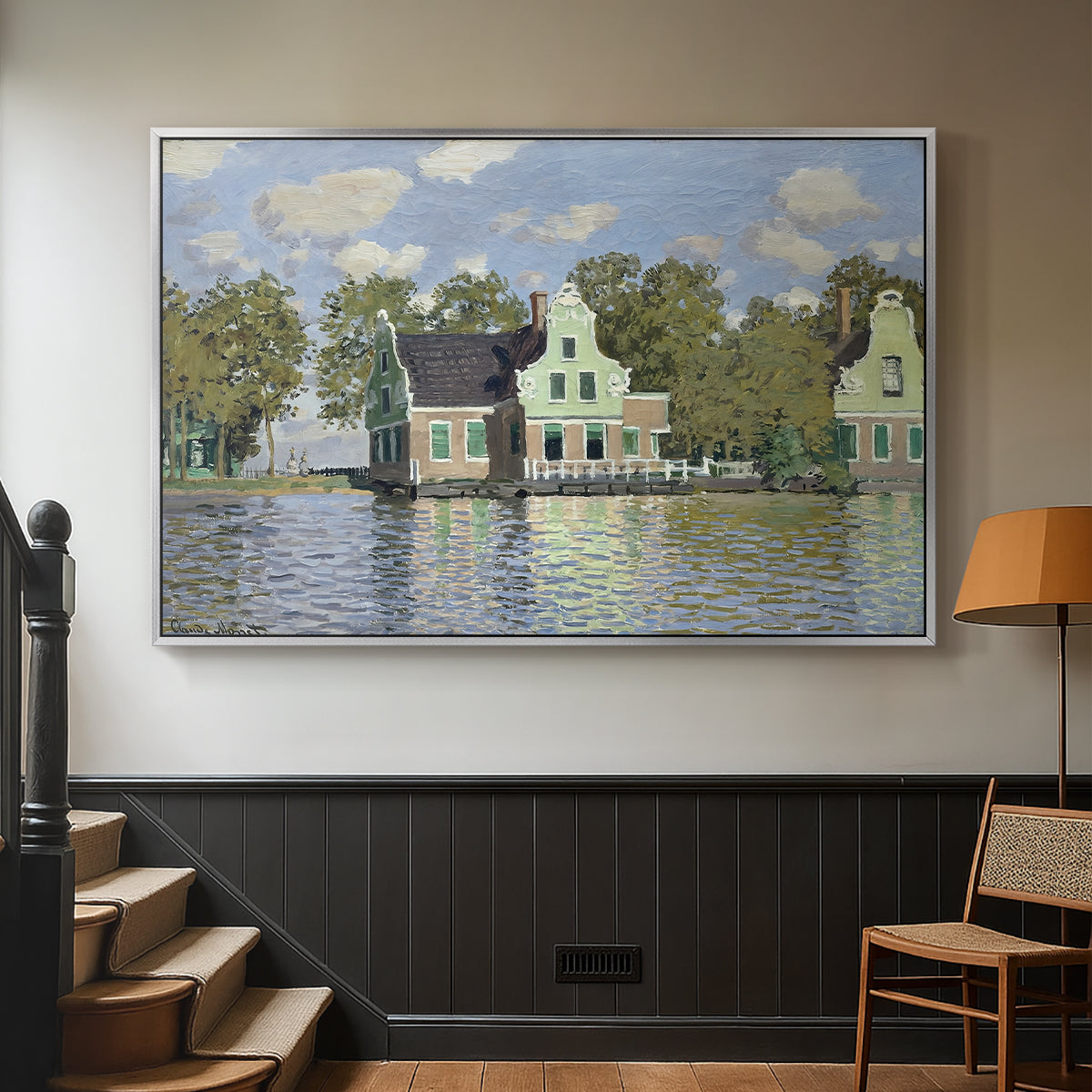 Silver floater framed canvas featuring a waterfront architecture with still reflections, displayed in a hallway near a staircase.