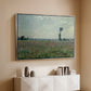 Silver floater framed canvas of Poppy Field, 1881 by Claude Monet, featuring an impressionist landscape filled with blooming flowers and greenery above a console cabinet in a minimalist entryway.