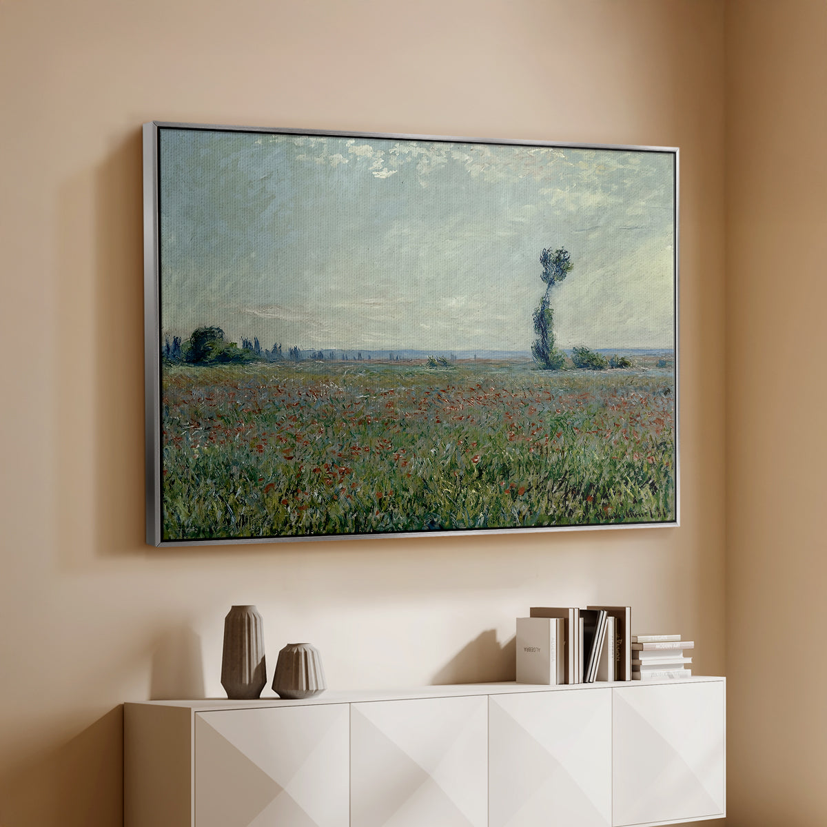 Silver floater framed canvas of Poppy Field, 1881 by Claude Monet, featuring an impressionist landscape filled with blooming flowers and greenery above a console cabinet in a minimalist entryway.