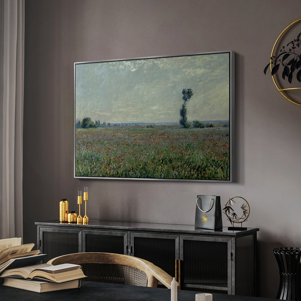 Poppy Field, 1881 by Claude Monet in a silver floater framed canvas featuring a rural meadow with scattered poppies and soft horizon, displayed above a desk in a dark home office interior.