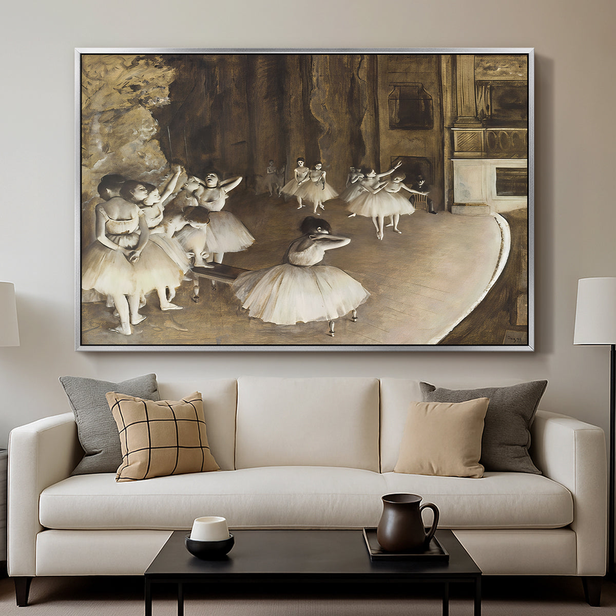 The Rehearsal of the Ballet Onstage, 1874 by Edgar Degas displayed in a silver floater framed canvas above a sofa in a clean living room.