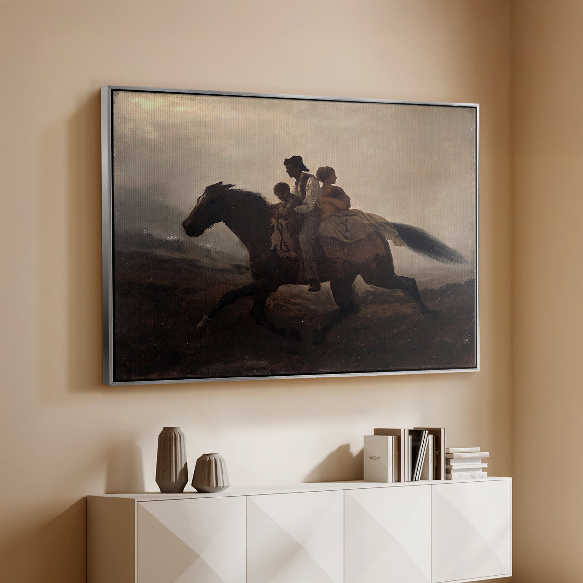 Silver floater framed canvas of A Ride for Liberty – The Fugitive Slaves, c. 1862 by Eastman Johnson, featuring a dramatic scene of enslaved people fleeing on horseback in darkness above a console cabinet in a minimalist entryway.