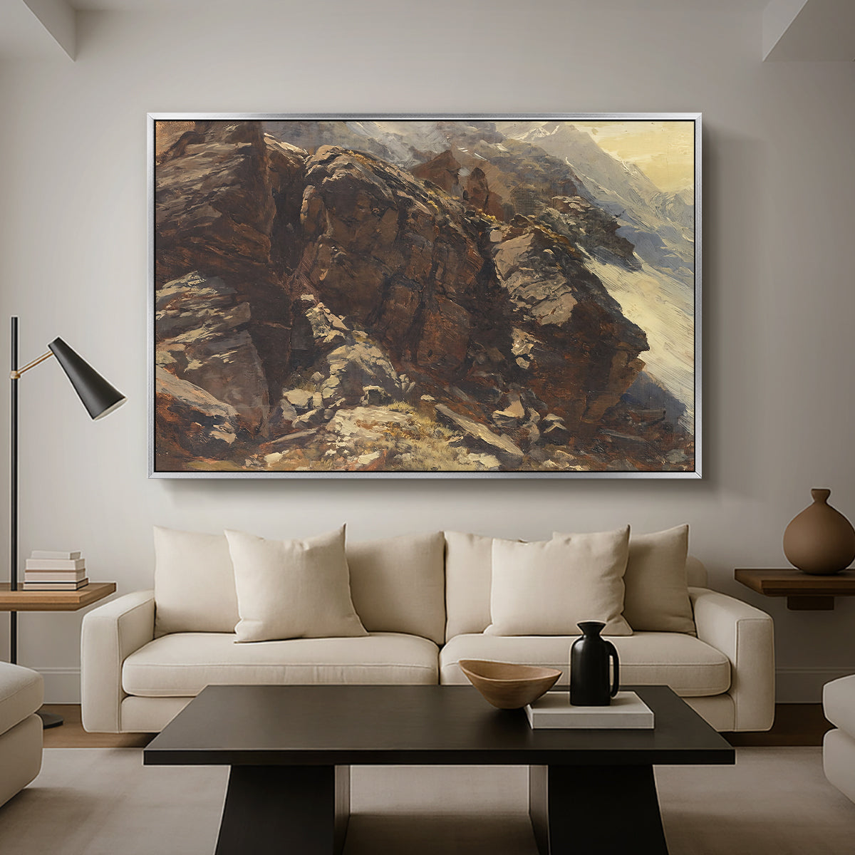High Mountain Study, c. 1870 by Edward Theodore Compton as a silver floater framed canvas featuring a rocky alpine terrain with steep slopes and distant mountain peaks, displayed above a sofa in a modern living room.
