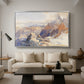 Col du Géant, 1903 by Edward Theodore Compton as a silver floater framed canvas featuring a mountain pass with snow-covered peaks and expansive alpine valley, displayed above a sofa in a modern living room.