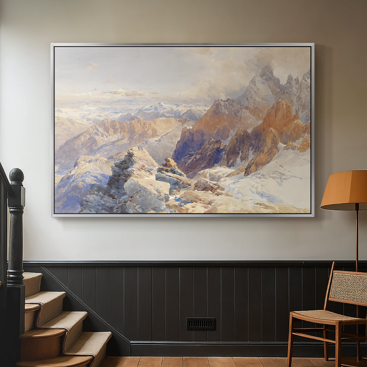 Silver floater framed canvas featuring a rugged mountain pass scene with distant peaks, displayed in a hallway near a staircase.