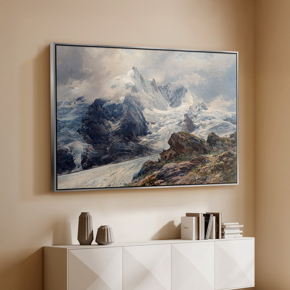 Silver floater framed canvas of The Grossglockner, 1880 by Edward Theodore Compton, featuring a dramatic mountain summit with snow and rugged slopes above a console cabinet in a minimalist entryway.