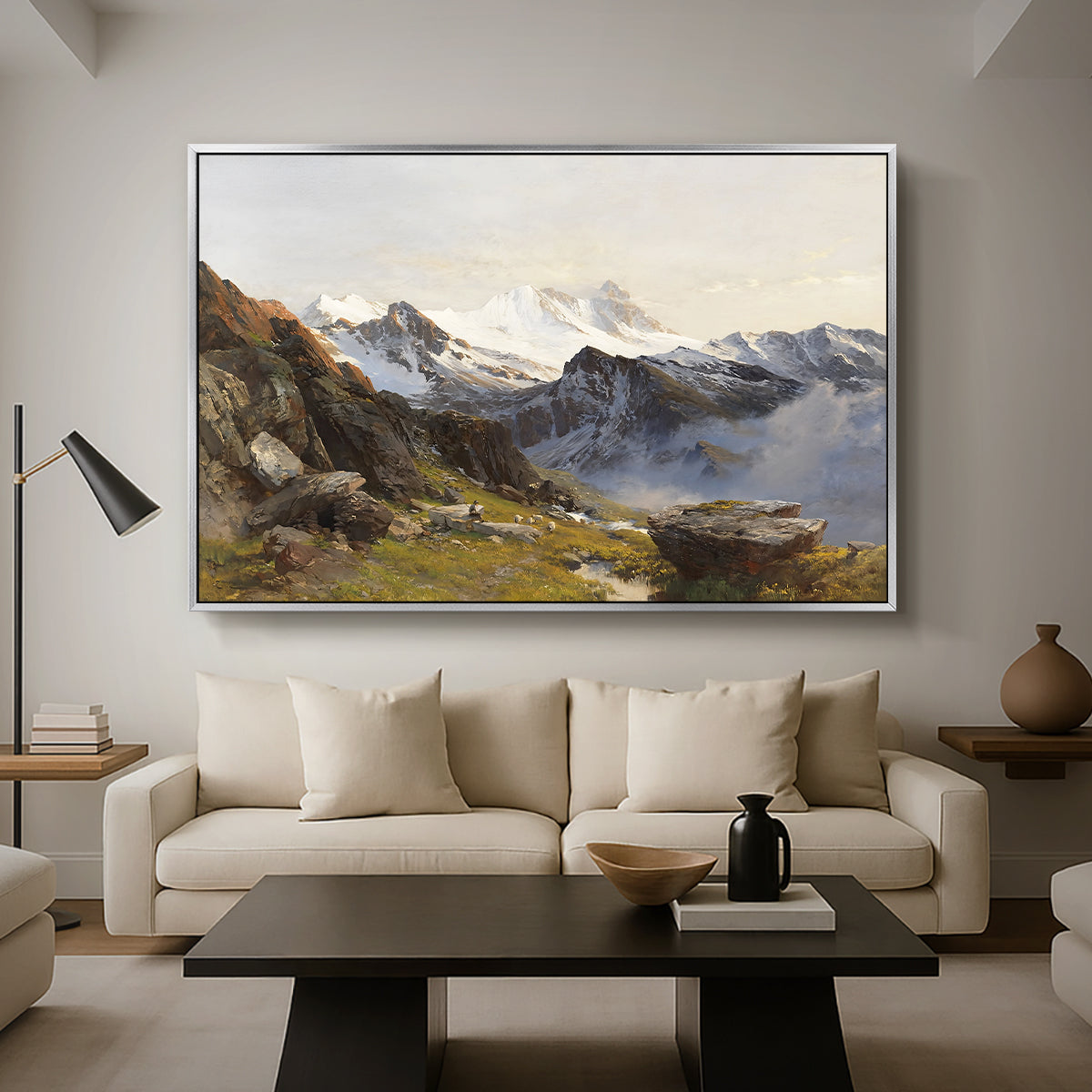 The Großglockner from the Prager Hut, 1890 by Edward Theodore Compton as a silver floater framed canvas featuring a view of Großglockner peak from alpine hut overlooking valley, displayed above a sofa in a modern living room.