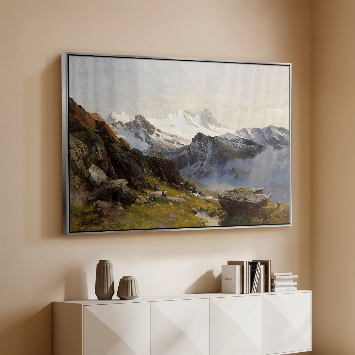 Silver floater framed canvas of The Großglockner from the Prager Hut, 1890 by Edward Theodore Compton, featuring a mountain summit seen from elevated viewpoint with surrounding landscape above a console cabinet in a minimalist entryway.