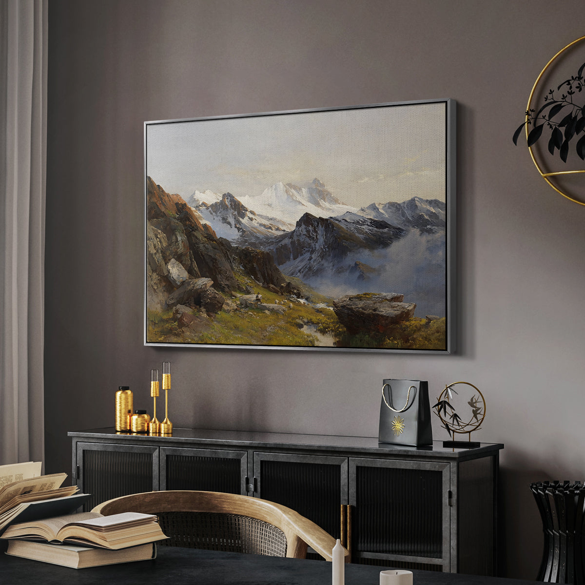 The Großglockner from the Prager Hut, 1890 by Edward Theodore Compton in a silver floater framed canvas featuring an alpine vista with towering peak and foreground terrain, displayed above a desk in a dark home office interior.