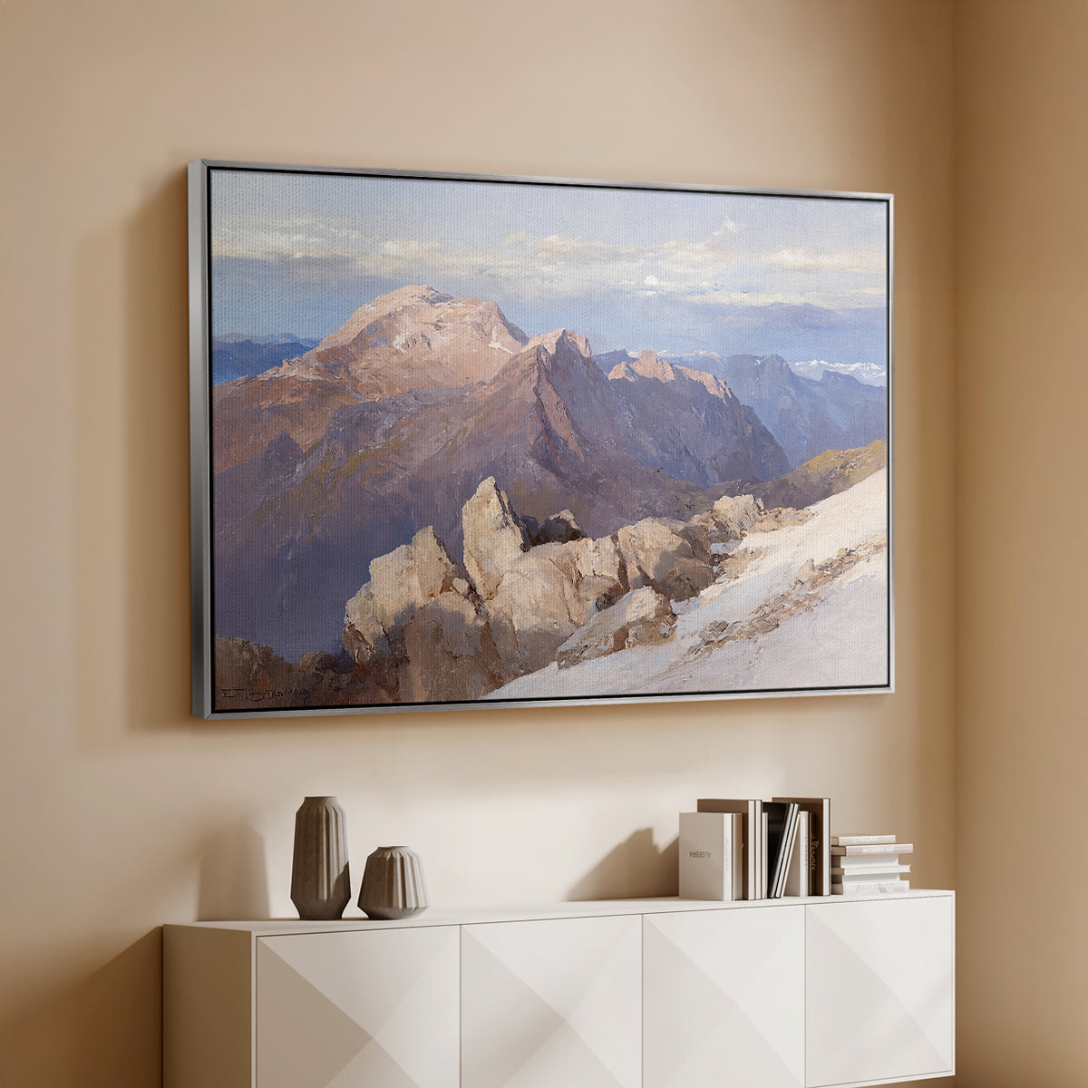 Silver floater framed canvas of Hoher Göll from Watzmann-Hocheck, 1919 by Edward Theodore Compton, featuring an alpine panorama showing layered peaks and valleys above a console cabinet in a minimalist entryway.
