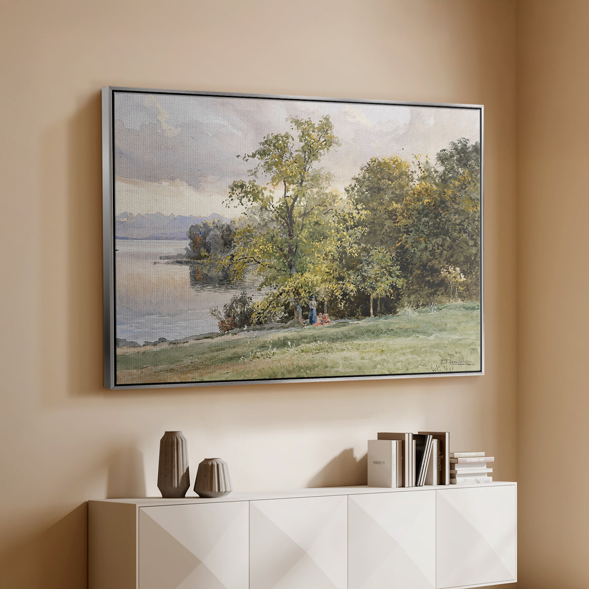 Silver floater framed canvas of Landscape at Lake Starnberg, 1890 by Edward Theodore Compton, featuring a peaceful lake scene with reflections and surrounding greenery above a console cabinet in a minimalist entryway.