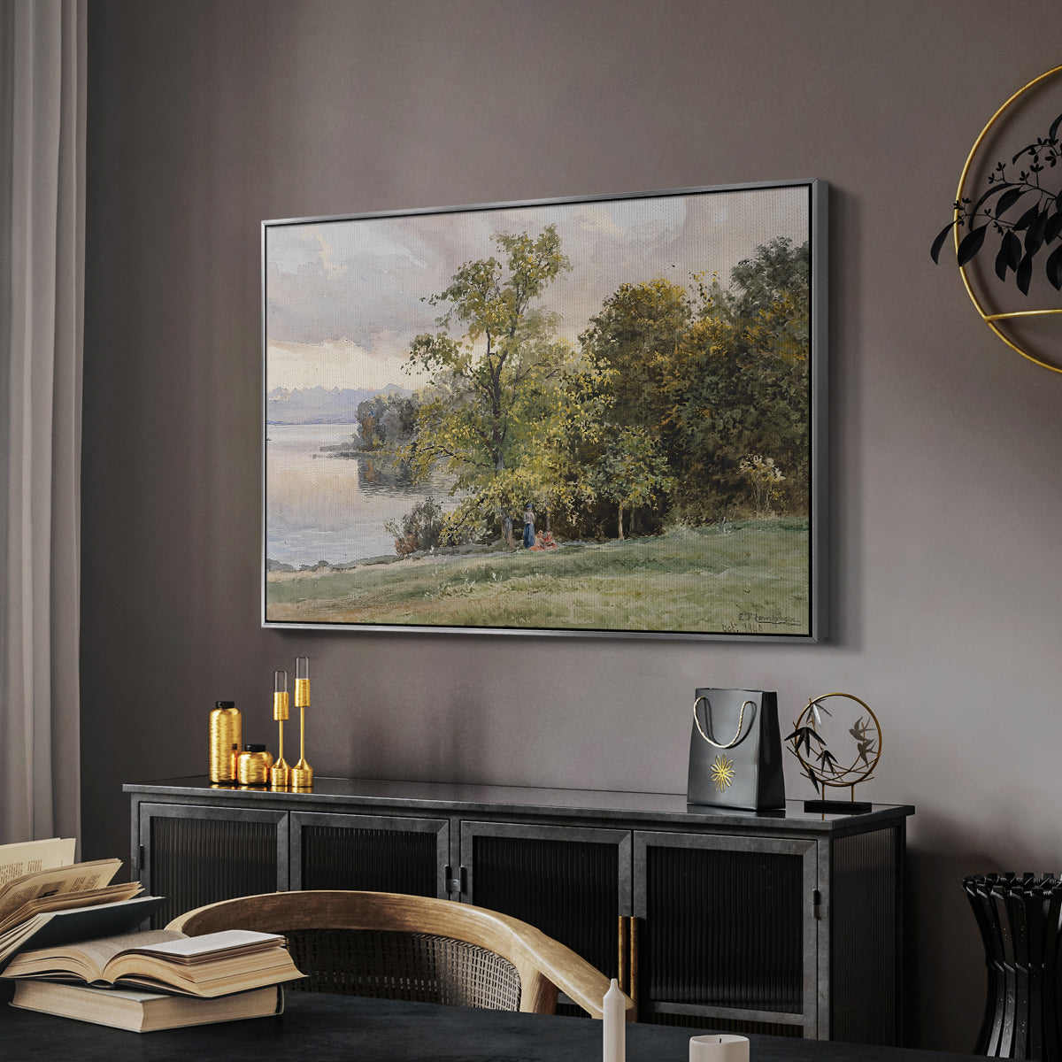 Landscape at Lake Starnberg, 1890 by Edward Theodore Compton in a silver floater framed canvas featuring a natural setting with water, trees, and open sky, displayed above a desk in a dark home office interior.