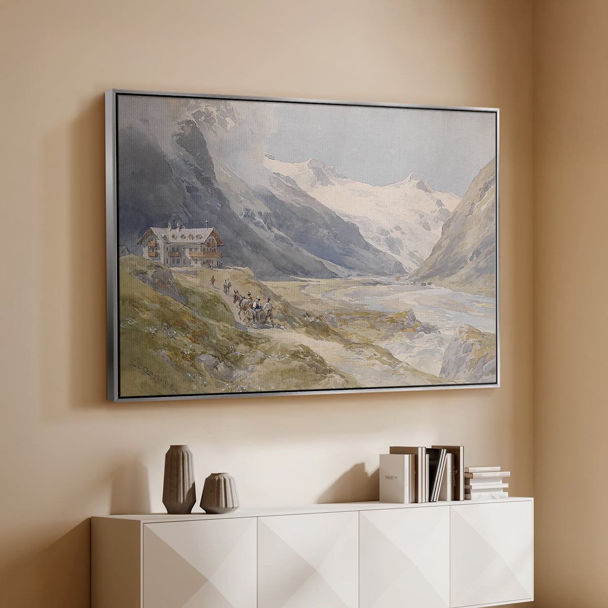 Silver floater framed canvas of Shepherds (Pasterze), c. 1921 by Edward Theodore Compton, featuring a pastoral mountain scene with figures tending livestock above a console cabinet in a minimalist entryway.