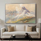 From the Dolomites, 1904 by Edward Theodore Compton displayed in a silver floater framed canvas above a sofa in a clean living room.