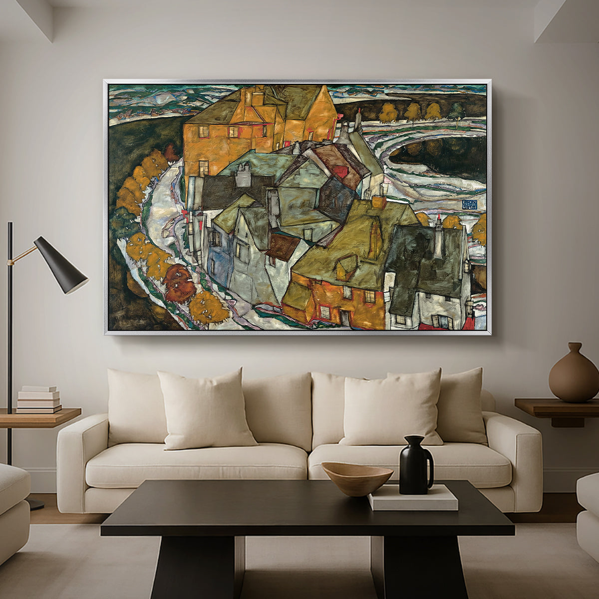 Crescent of Houses II (Island Town), 1915 by Egon Schiele as a silver floater framed canvas featuring a curved row of colorful houses forming crescent shape along water, displayed above a sofa in a modern living room.
